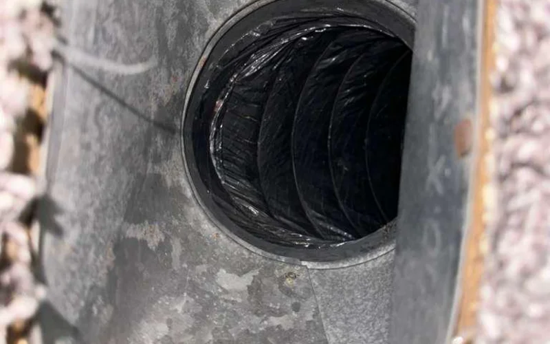 Sheet-metal plenum surrounded by loose attic insulation