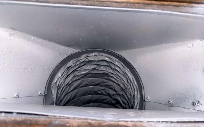 Interior of a cleaned supply plenum with the duct takeoff visible